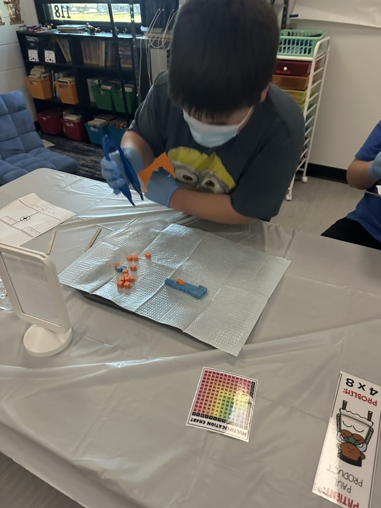 students doing pretend surgery using multiplication