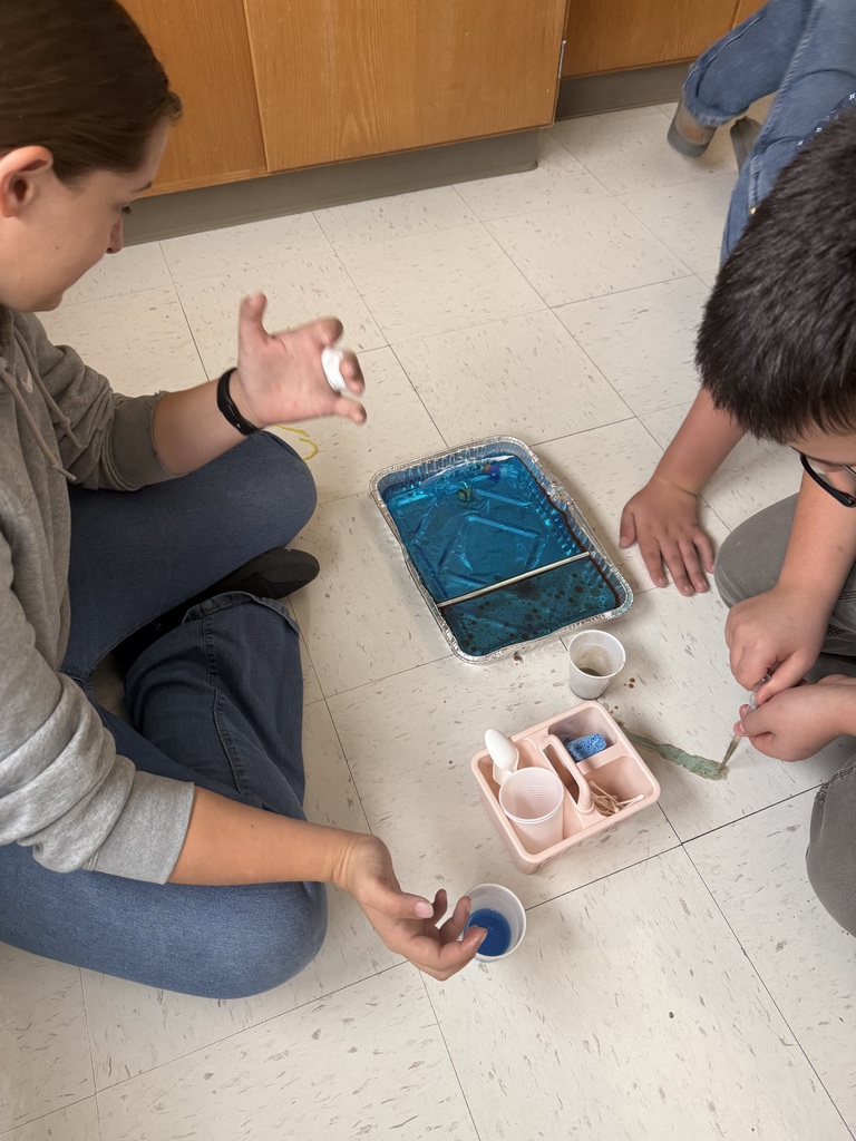 students experimenting with oil and dish soap
