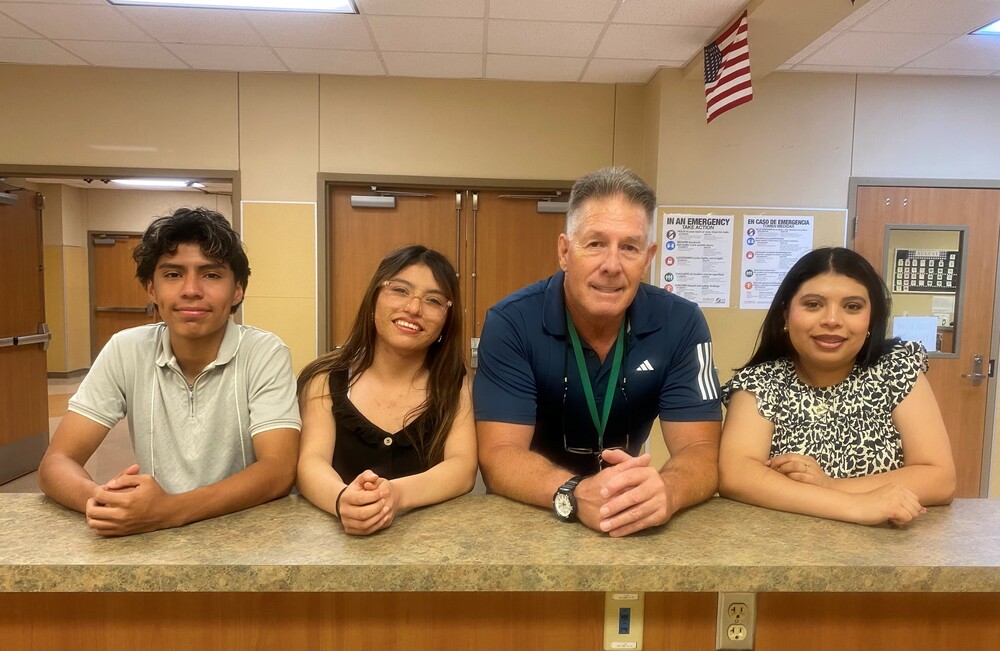 Spanish Teacher Michael Cole with 3 of his students who are siblings