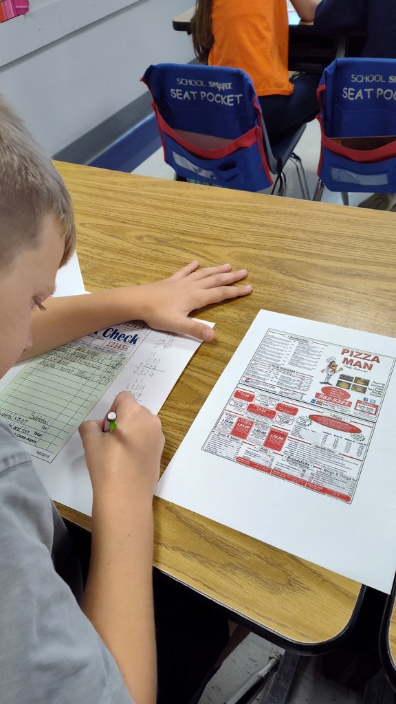 Students filling out their orders from Pizza Man and calculating their tax and totals.