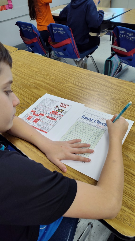 Students filling out their orders from Pizza Man and calculating their tax and totals.