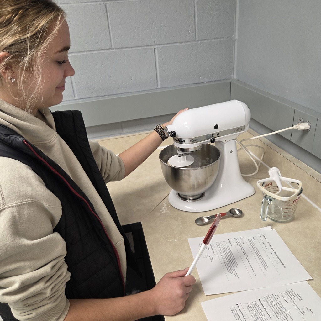 Student mixing bread.
