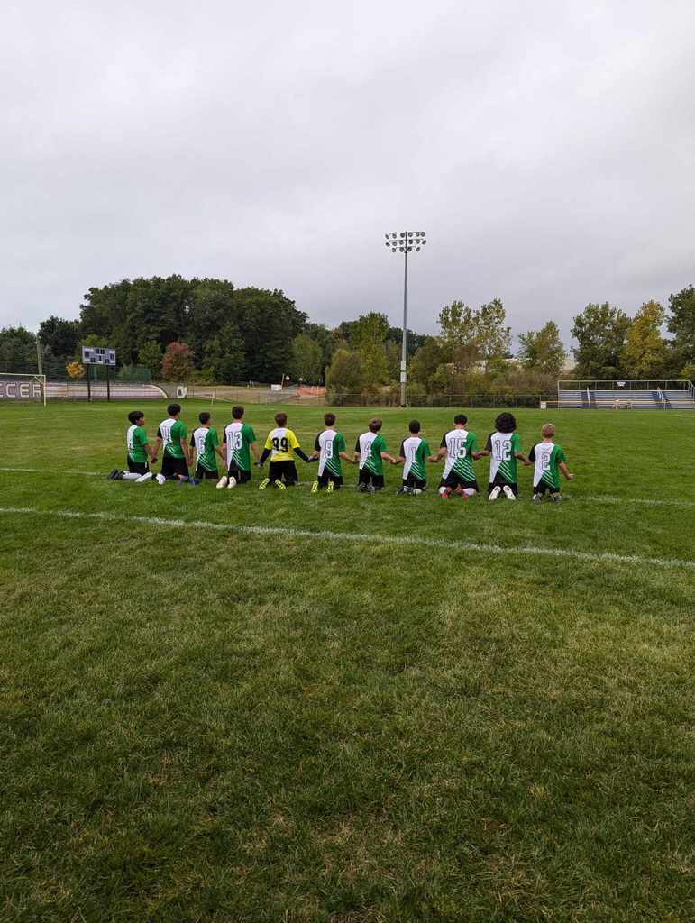 Soccer team praying