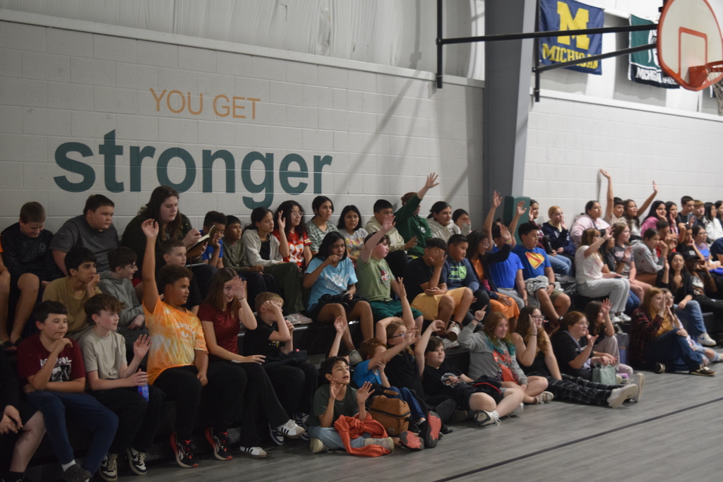 Student participants raising hands.