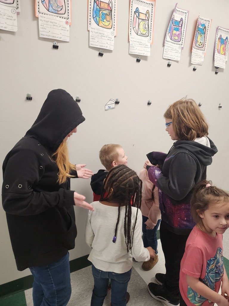 5th Graders and Kindergarteners searching for and reading words. 