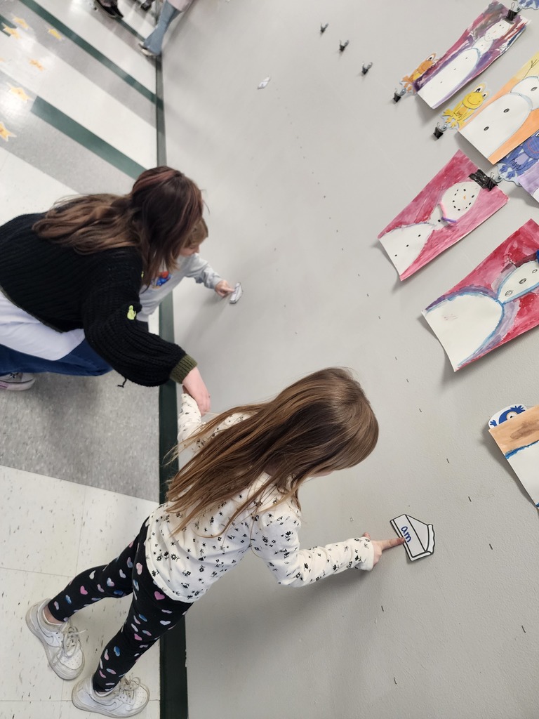 5th Graders and Kindergarteners searching for and reading words. 