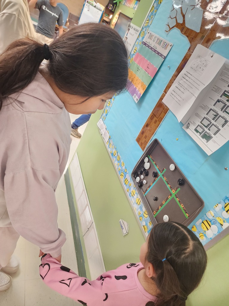 5th Graders and Kindergarteners searching for and reading words. 