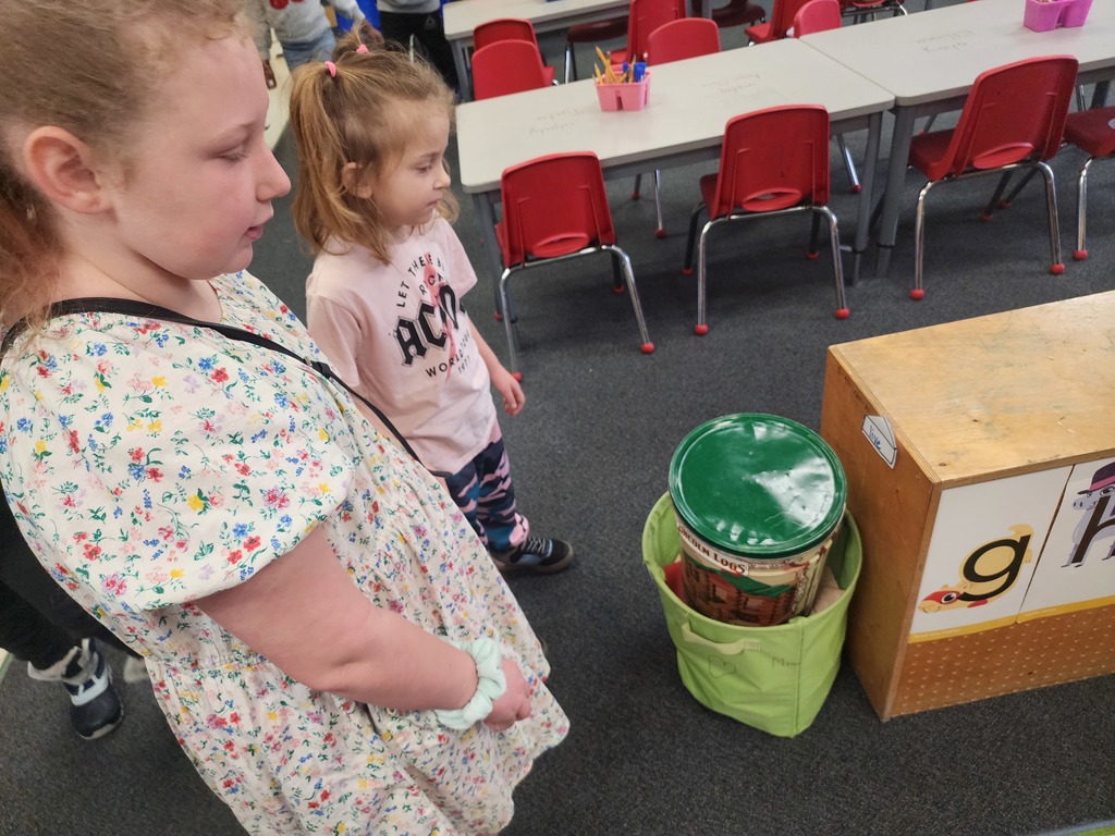 5th Graders and Kindergarteners searching for and reading words. 