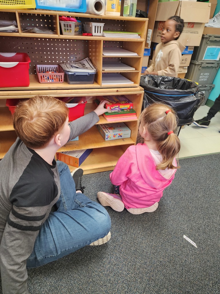 5th Graders and Kindergarteners searching for and reading words. 