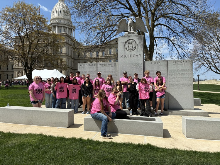 students in pink Raise Your Voice t-shirts