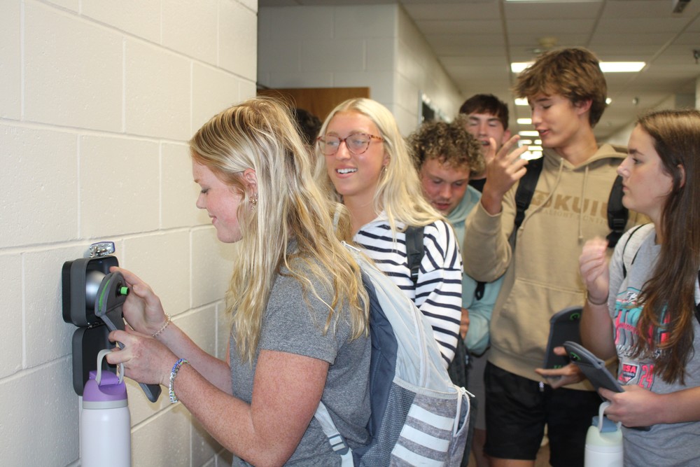Students rush to unlock their phones after the final bell.
