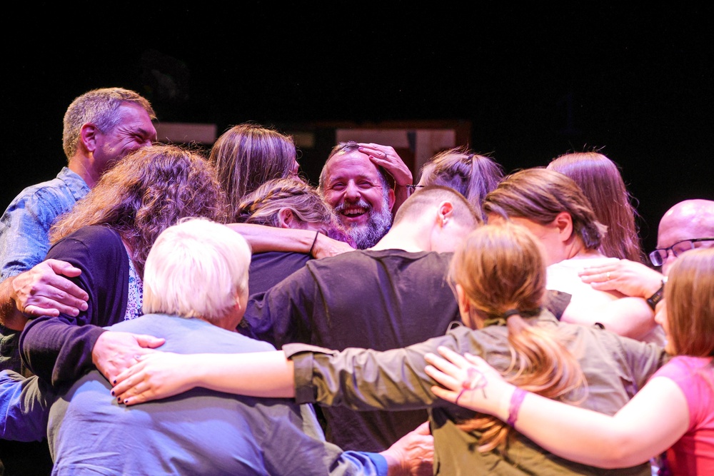 One last hug during the open house held in the honor of T. Adam Goos