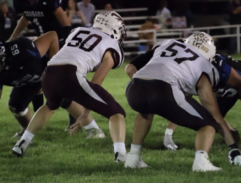 # 50 Trace Tramp and # 57 Trey Tramp get down in their stance ready for the next play.