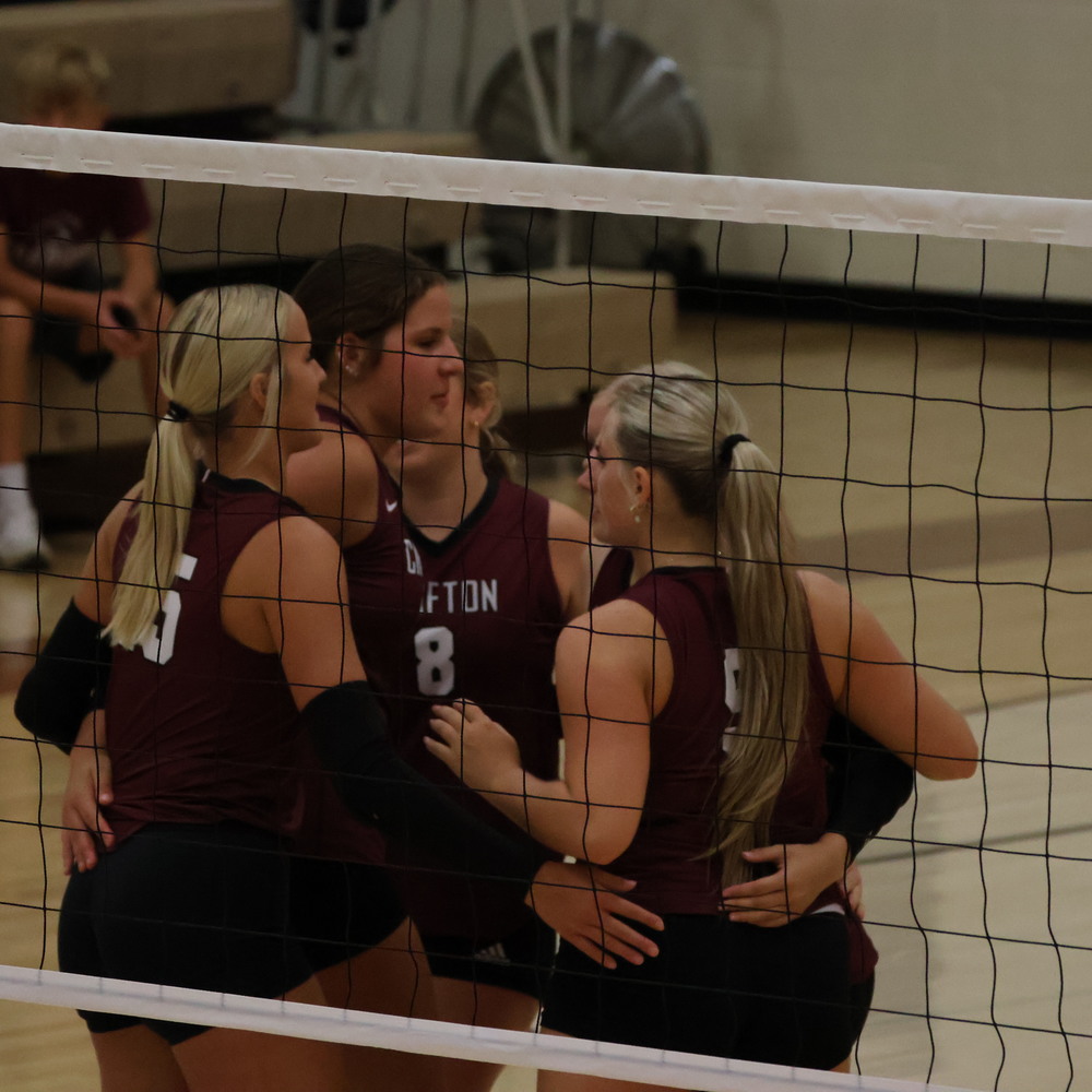 The team huddles up after a point.