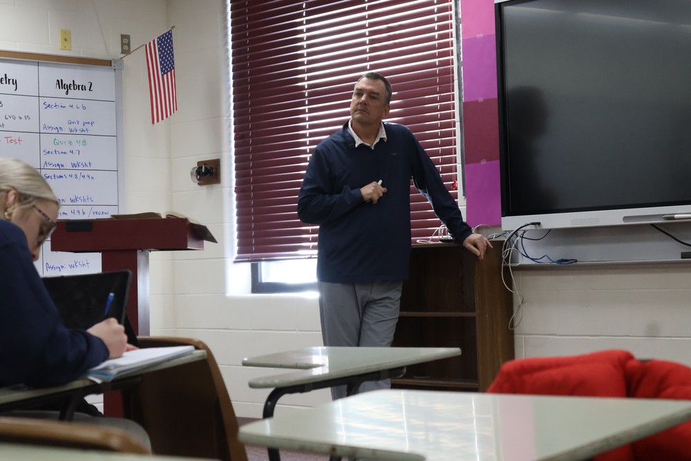Mr. Hall lectures his college math class.