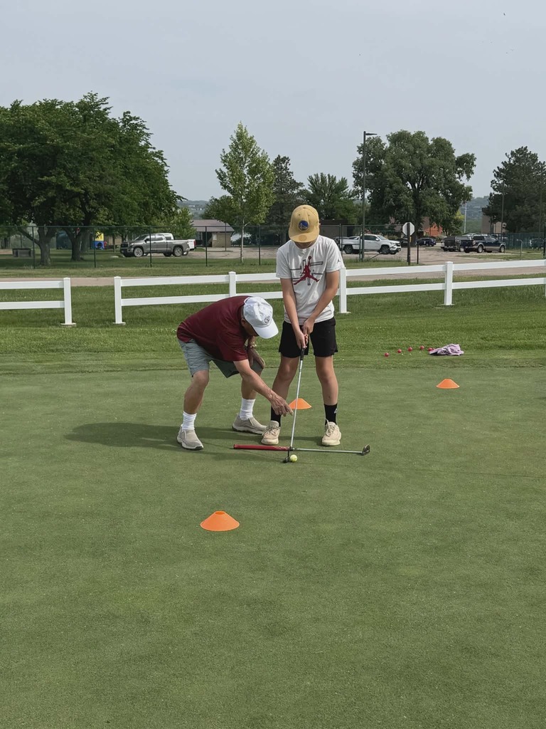 Joe Janssen instructs Braxton Hames on lining up his putt