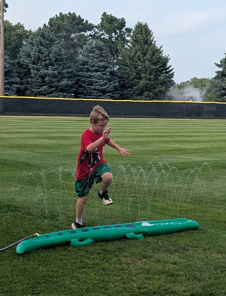 Zachary DeRoos navigates a water obstacle during the triathlon.