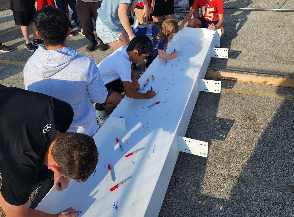 JH staff & students signing the beam