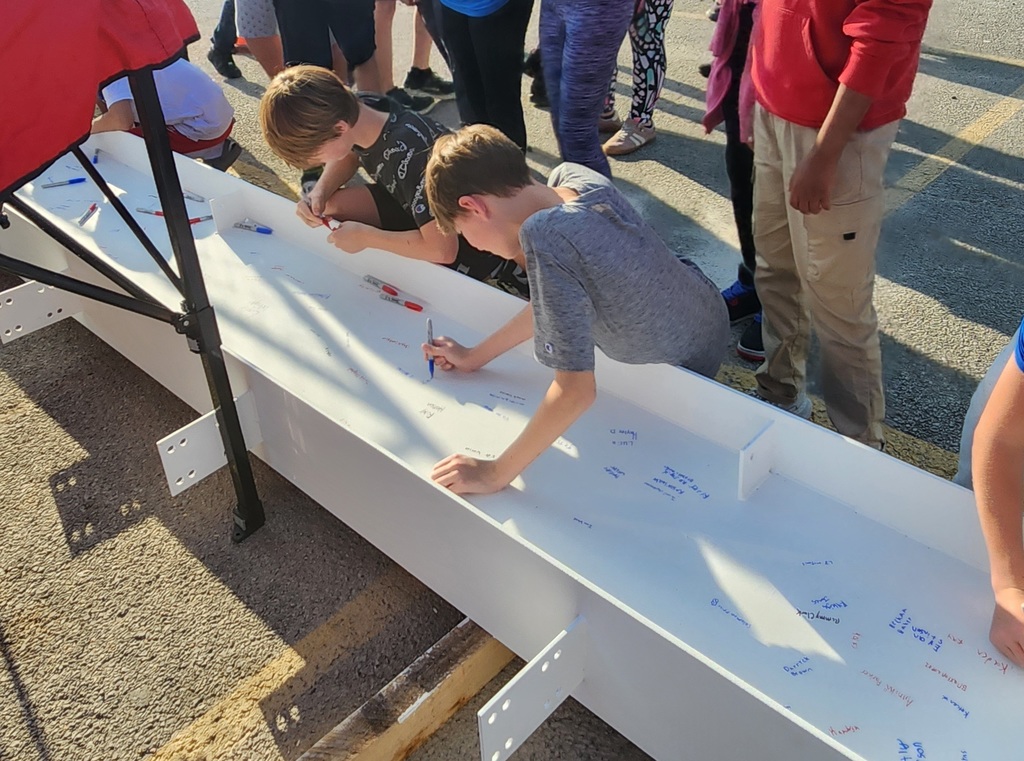 JH staff & students signing the beam