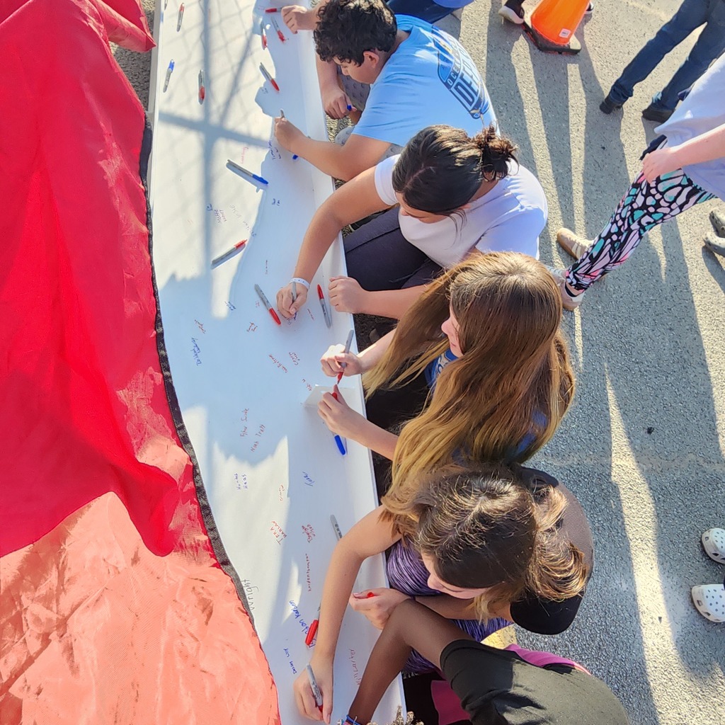 JH staff & students signing the beam