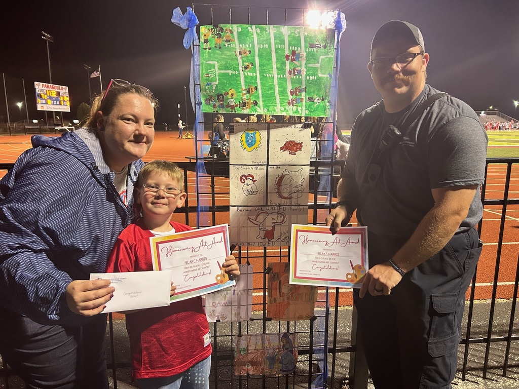 Blake Harris poses with his parents and his award winning art contest entry