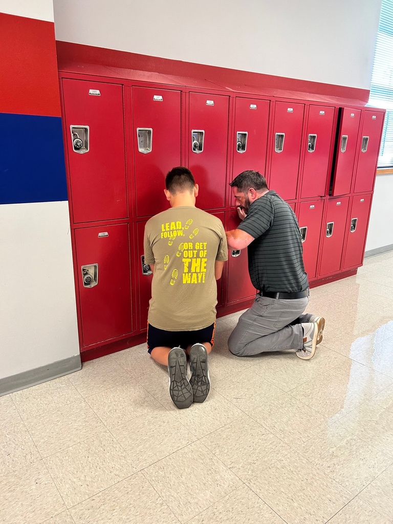 Mike Chipman helps a student with his locker