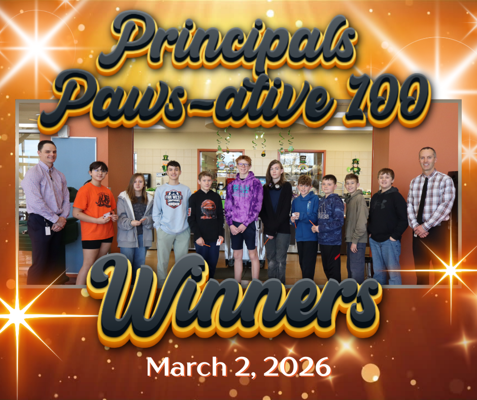 A group of students with two staff standing in a cafeteria