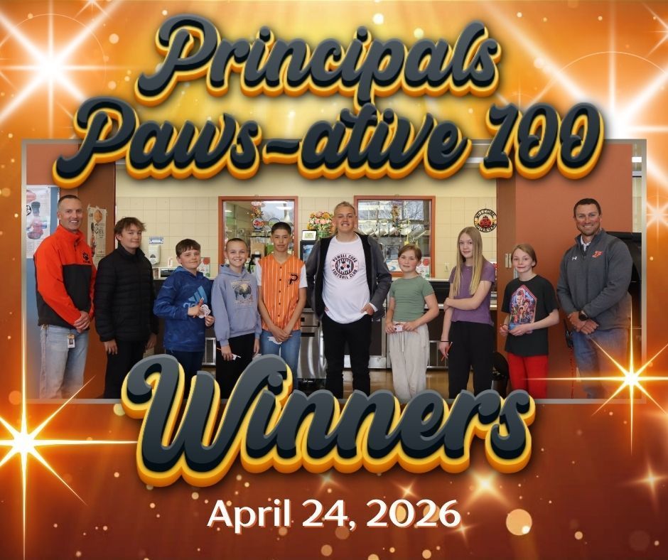 A group of students standing in a cafeteria with two principals.