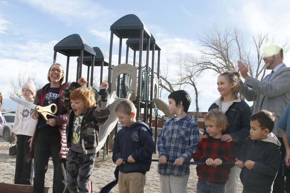 Cutting the ribbon on our two new playgrounds