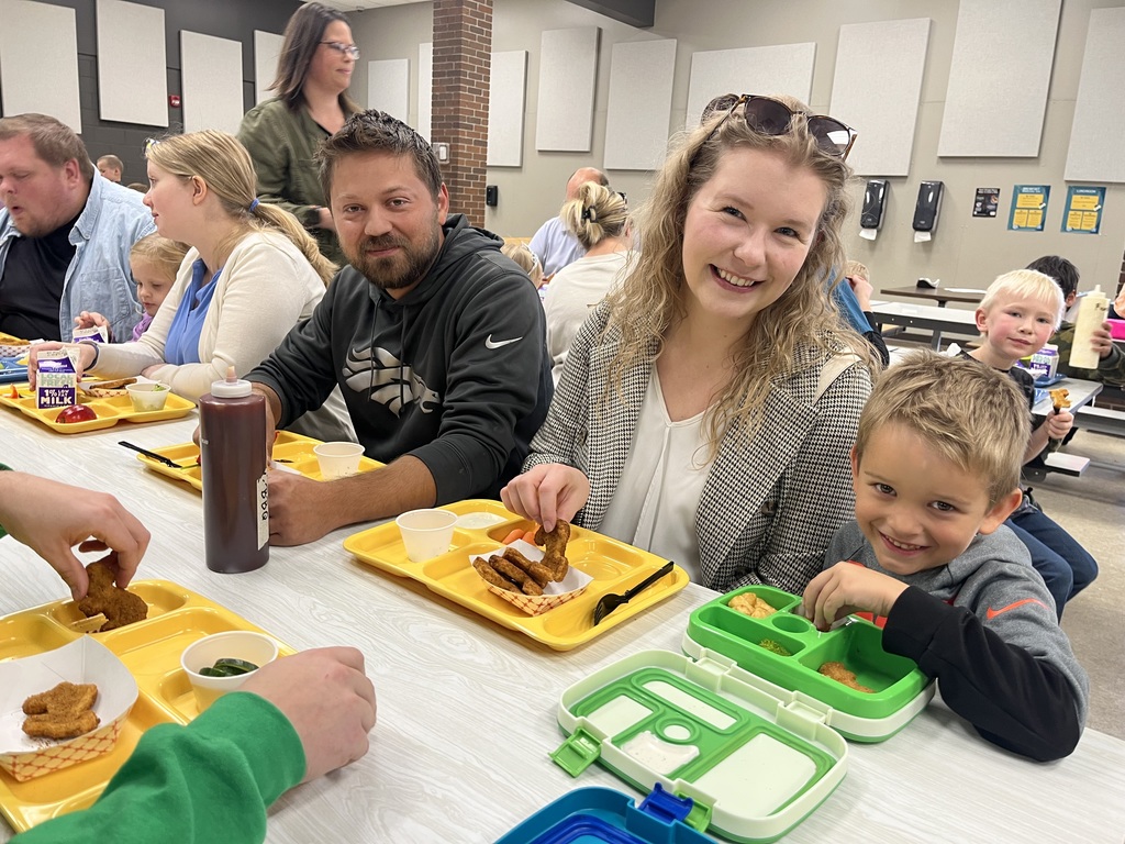 Mom and dad eating lunch with their son