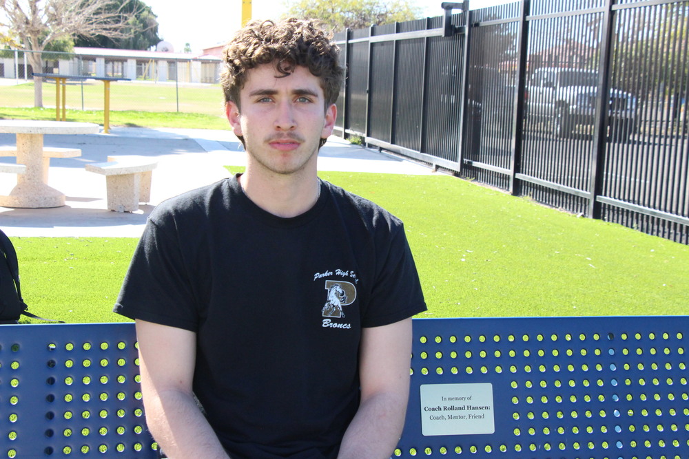 Abraham Andrade Sitting on a Bench Dedicated to Mr. Hansen,