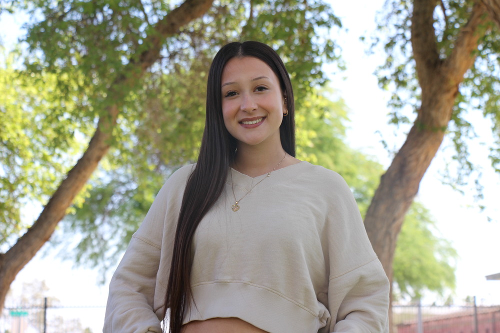 AnaMarie smiling with trees in the background