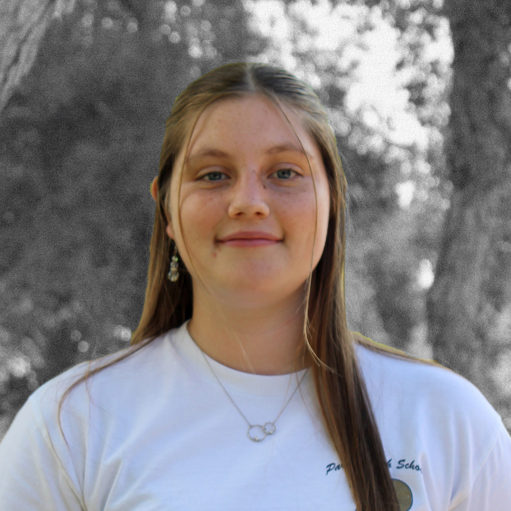 Emilia smiling for the camera in the campus courtyard