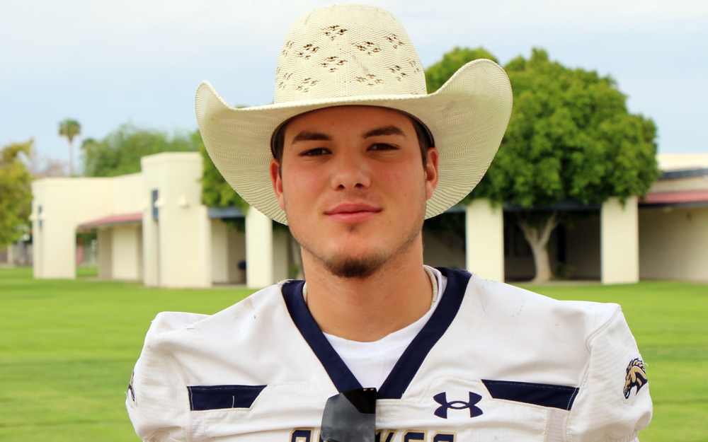 Fernando with his football jersey and cowboy hat on the south green of the campus