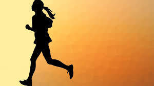 silhouette of girl crosscounty runner against golden background