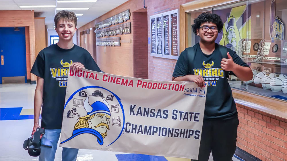 Brodric Wright and Angelo Sigrah hold up a banner made for them as they headed to State SkillsUSA Championships where they garnered gold.