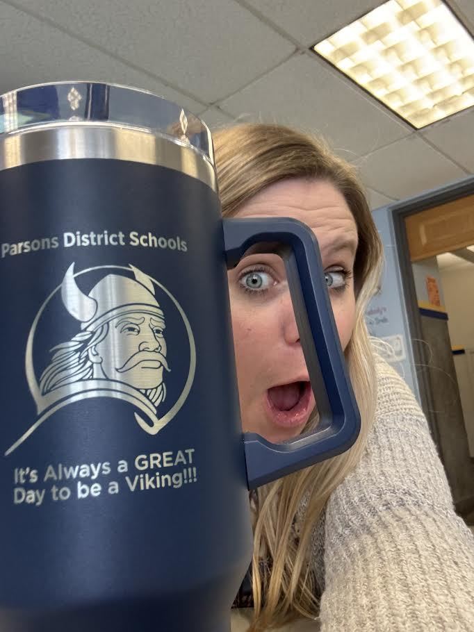 Millar peeks through the handle of her award mug.