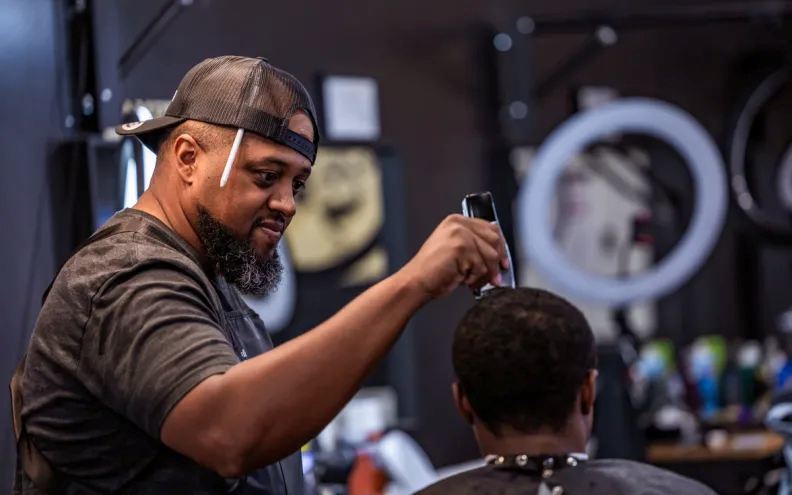 Martin Watson, Owner of Watsons Barber Shop in Lawrence, cuts a customers hair. (Photo by Molly Adams/Lawrence Times