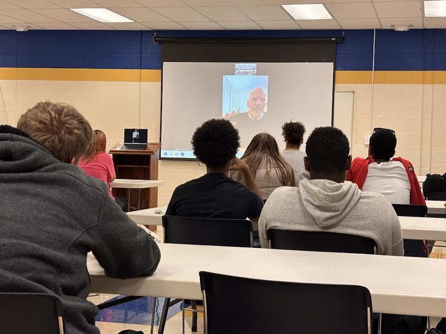 Tad Roach speaks to students via Zoom.