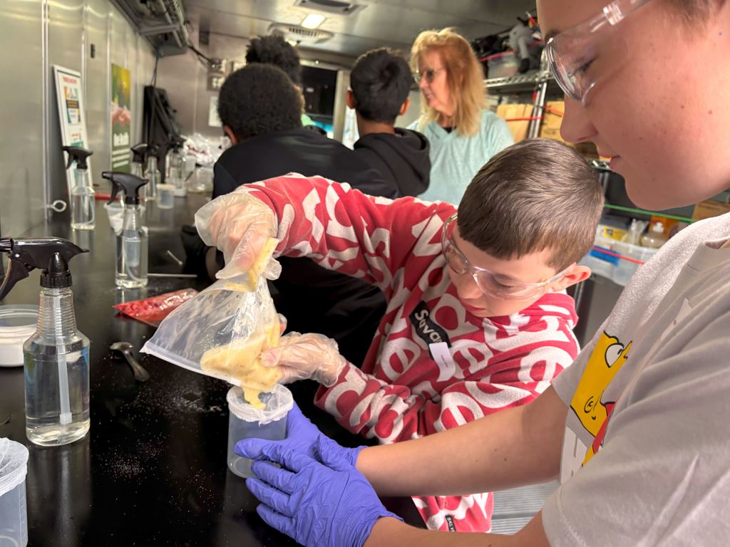 Students strain their fruit mixtures so only the liquid is in their beaker.