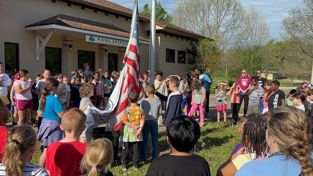 Parsons third grade students help raise the flag for the Pledge of Allegience.