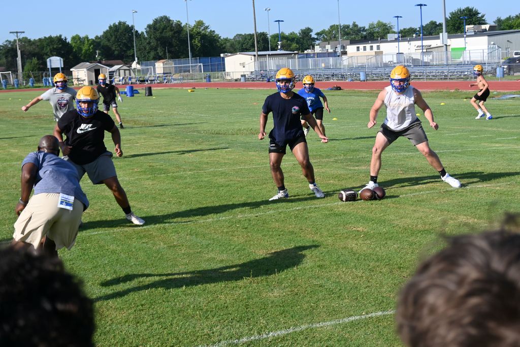Players run drills.