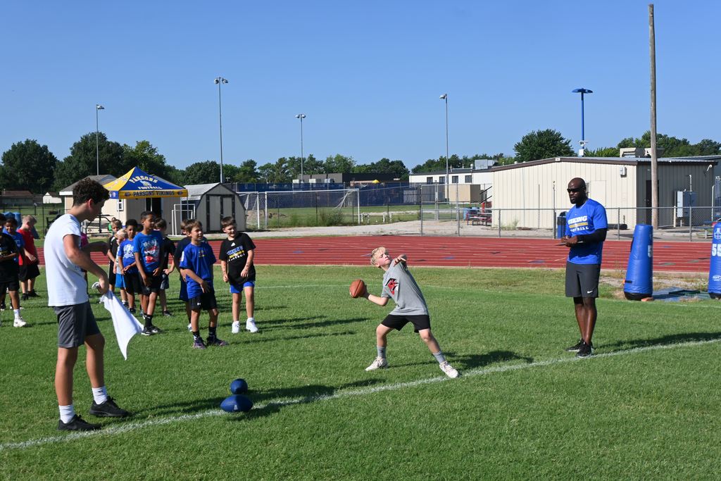 a boy prepares to pass the football.