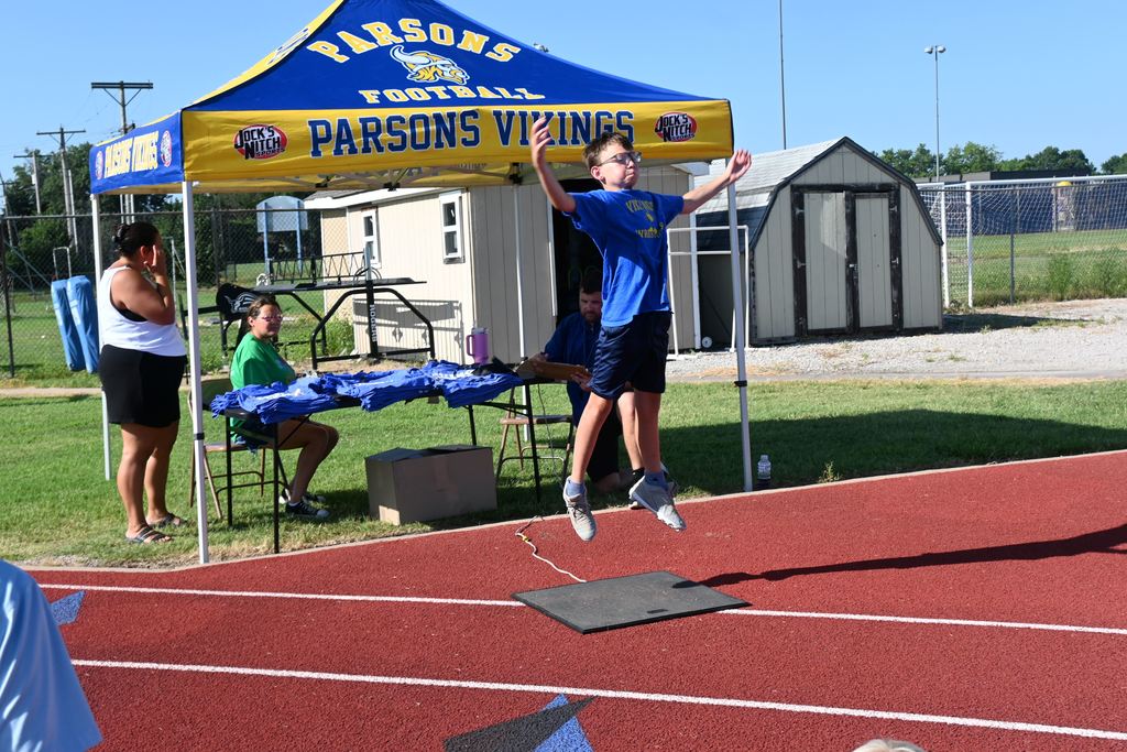 A boy springs up from a mat that will determine his vertical jump height.