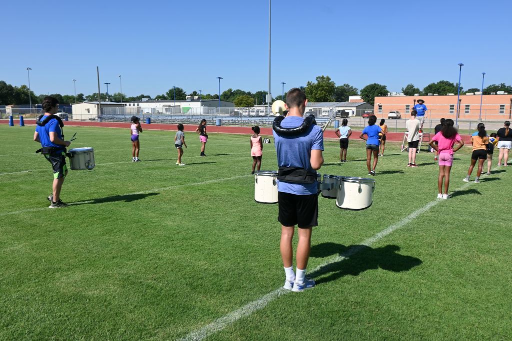 Band  and Viking Dance students practice marching formations.