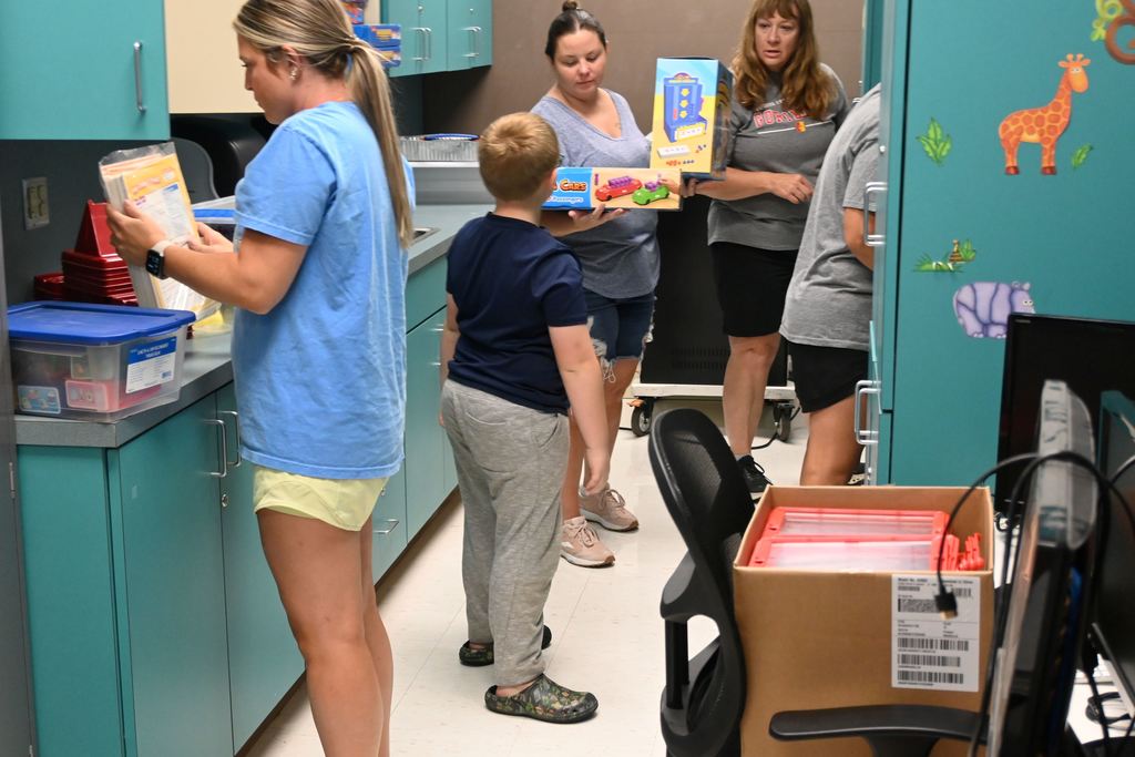 Lincoln teachers reorganize storage areas for classroom supplies.