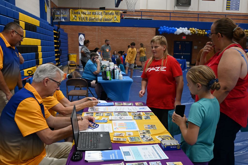 A family visit with members of the Lions Club that assists in the community with eye exams, glasses and diabetes education and kids camp.