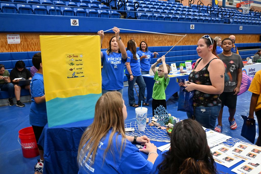 A students fishes for a prize at the Lincoln table.