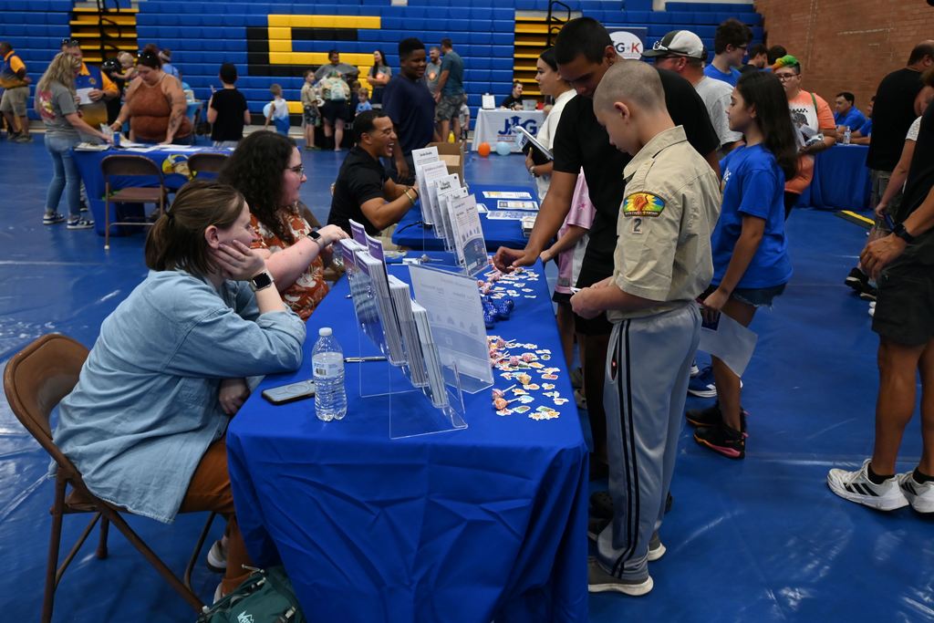 Students visit tables to learn more about resources.