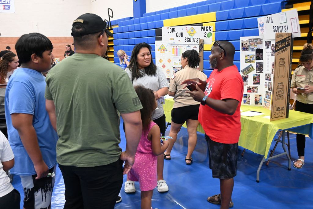 A family stops by to learn about getting involved in scouting.